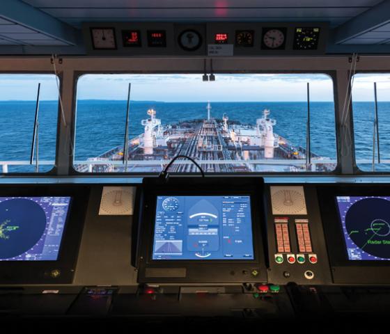 image of ship's bridge looking out to bow of ship and ocean 