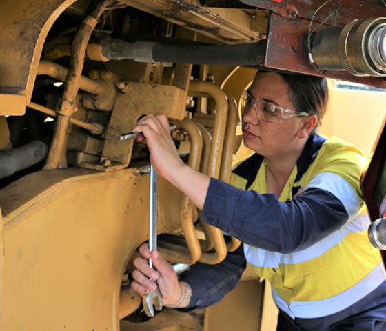 person servicing heavy plant equipment