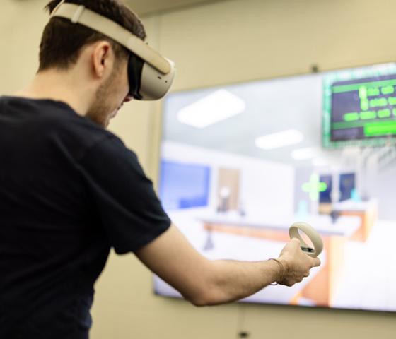 Person with VR headset develops game. 